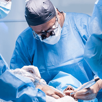 an oral surgeon performing the dental implant placement surgery