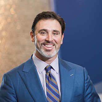 smiling man in a navy blue suit 