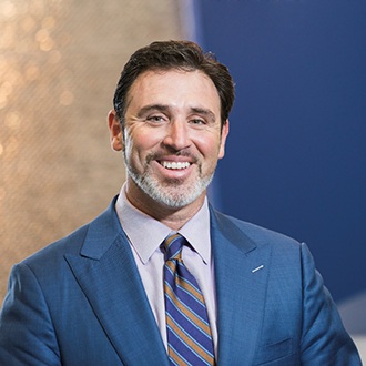 smiling man in a navy blue suit