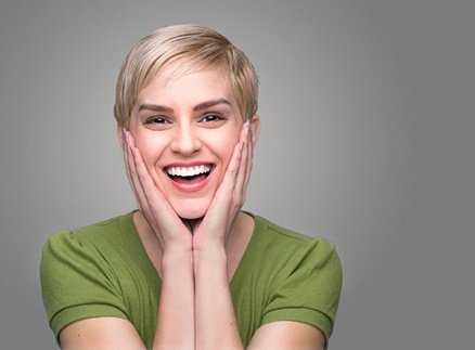 Smiling woman with dental crowns in Springfield