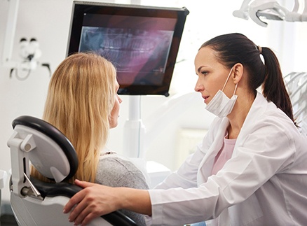 Dentist talking to emergency patient