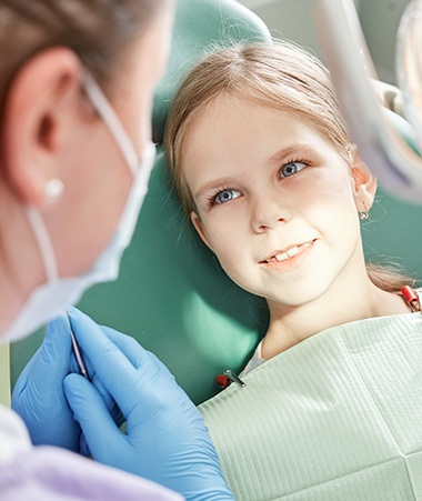 Young Springfield patient smiling during fluoride treatment