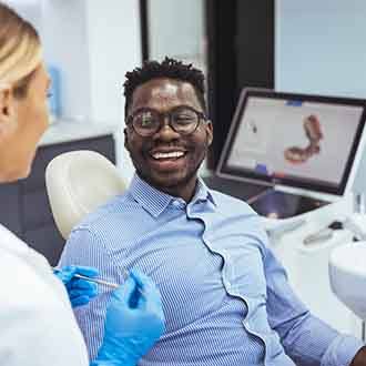 a patient visiting his dentist for dental implant care