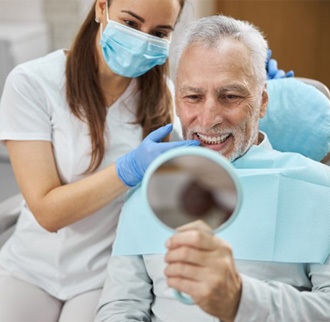 a patient checking his new dental implants