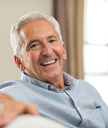 man smiling after getting dental implants in Springfield