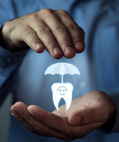 Hands holding an animated tooth under an umbrella