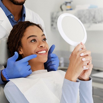 Woman smiling at reflection in mirror