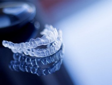 a pair of clear aligners on a glass table