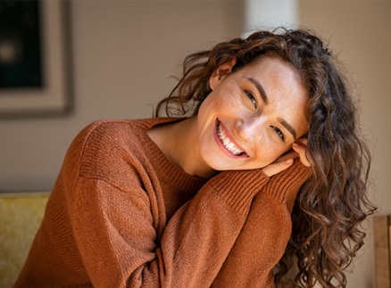 Woman smiling in living room