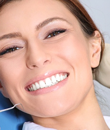 Young woman smiling in a dental chair