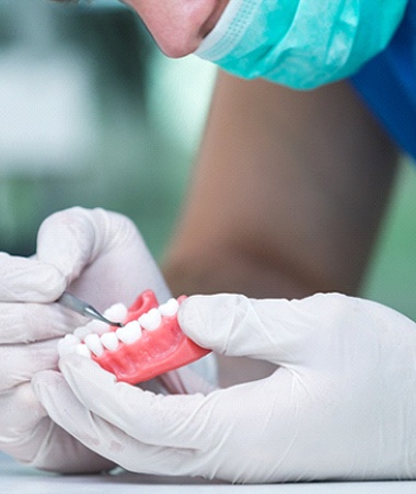 Dentist working on model of dentures