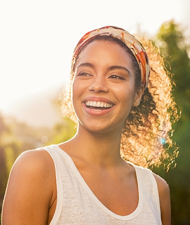 young woman smiling in the sun