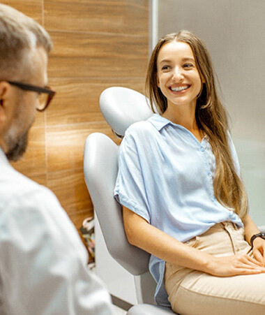 female patient smiling at dentist at dental appointment