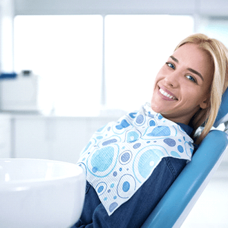 smiling woman sitting in dental office