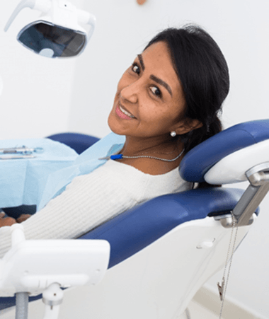 Female dental patient sitting in dental chair
