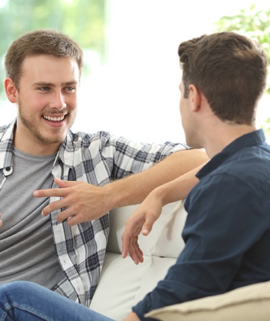 Patient in Springfield talking with friend after dental sealant treatment