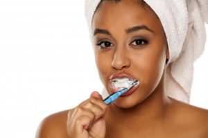 woman using desensitizing toothpaste