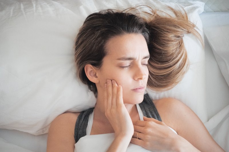 woman in bed with toothache