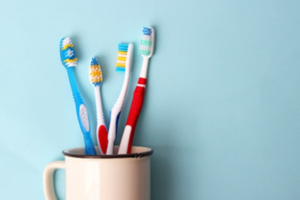 a closeup of toothbrushes in a cup